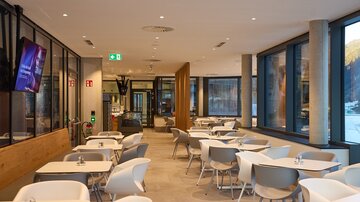 Thermal spa buffet with white and grey seating areas, large windows and modern interior design