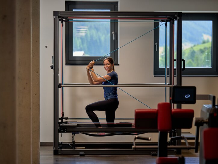 Woman training on cable machine in fitness studio