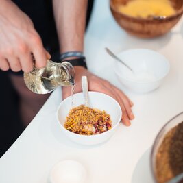 A Person prepares an aroma for an infusion and pours liquid into a bowl